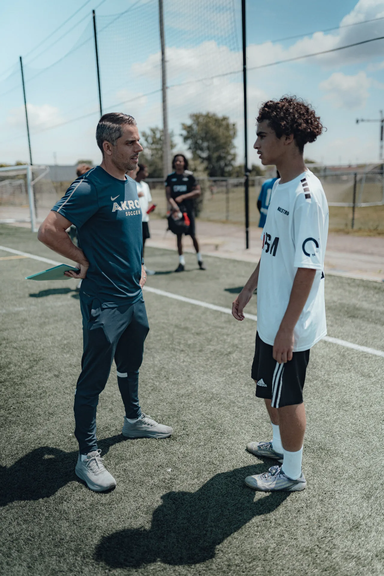 An OPSM advisor speaking with a player on the sideline