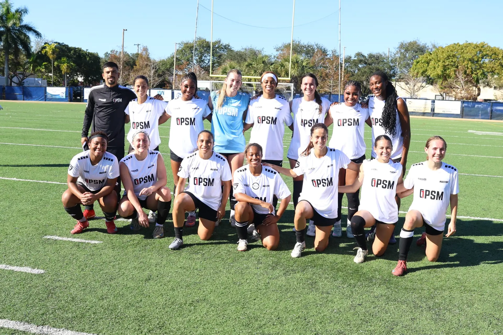 Team photo of the white squad with coaching staff