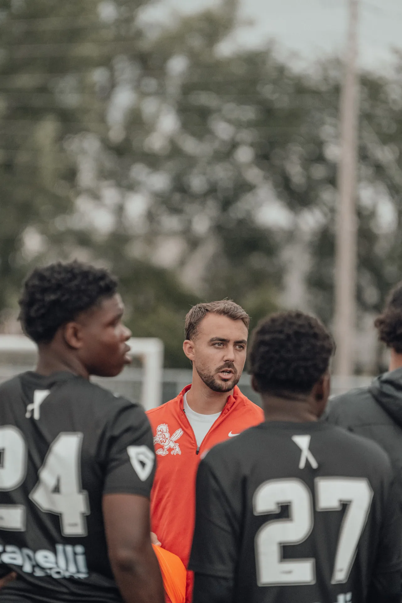 Coach giving instructions to a group of players