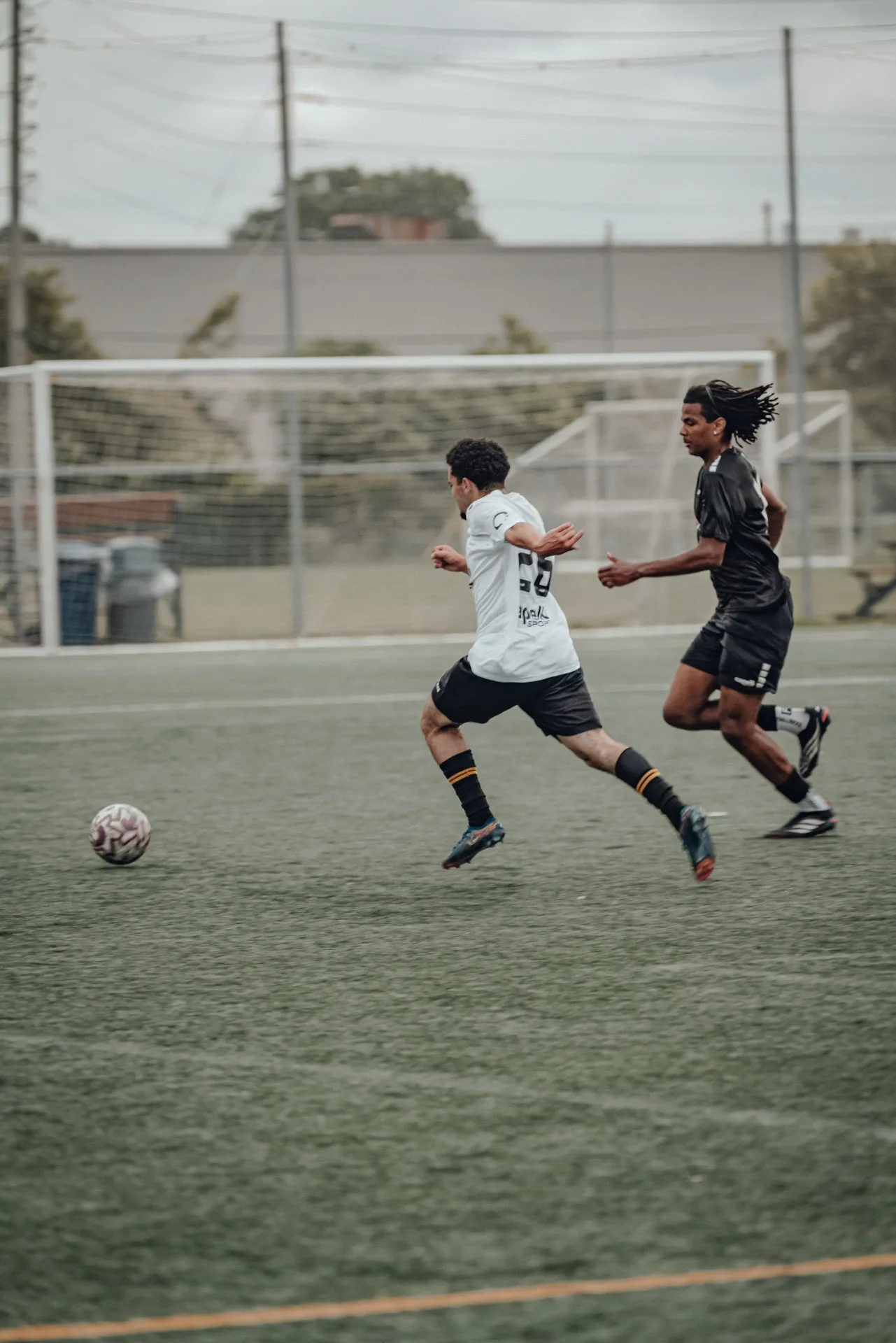 Two players sprinting after a loose ball