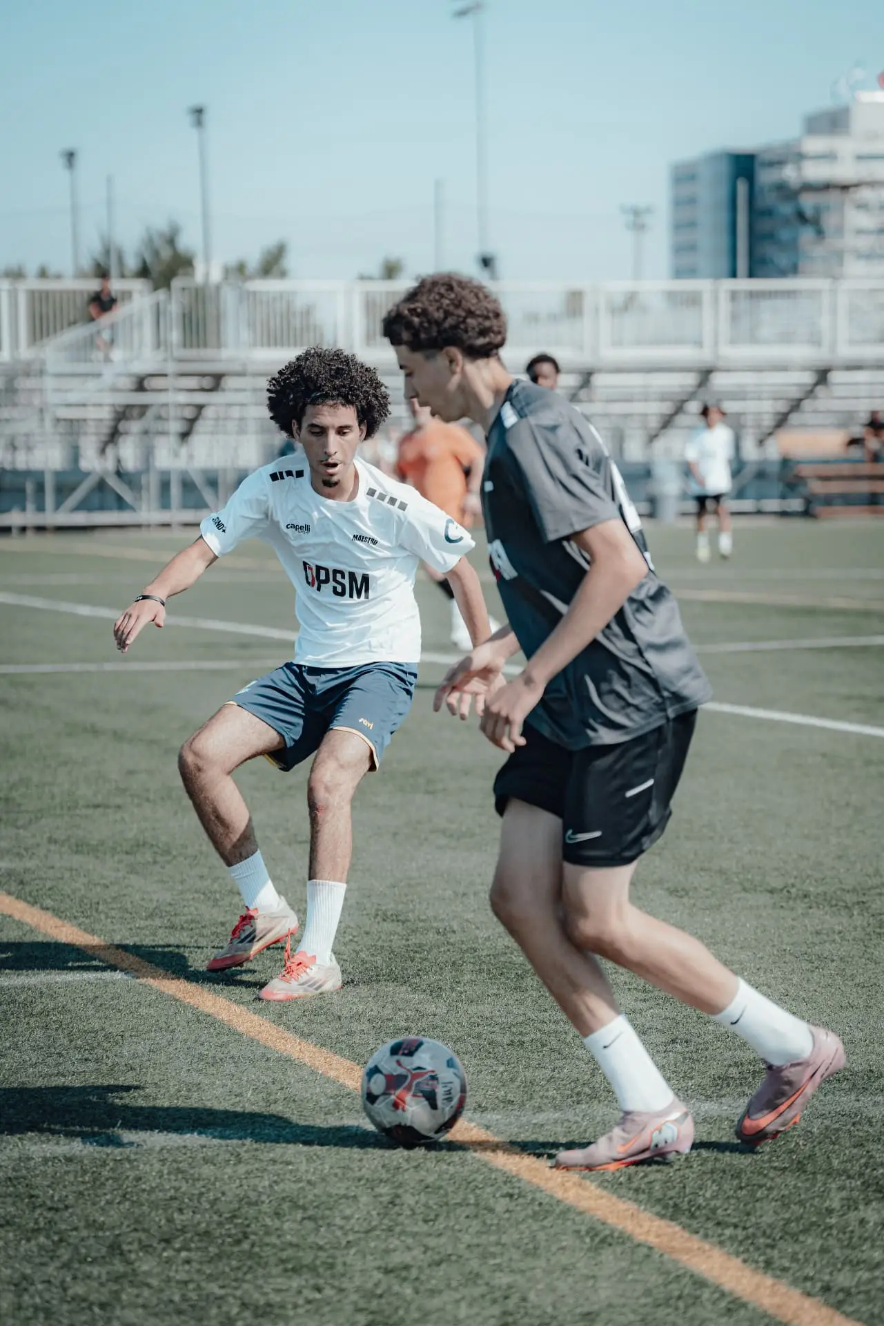 Player in white OPSM kit pressing an opponent