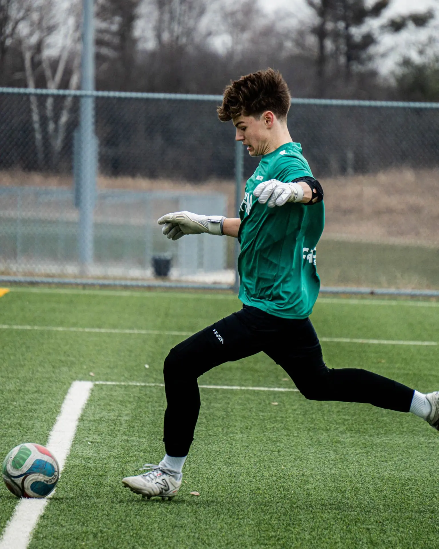 Goalkeeper striking a long distribution from the back