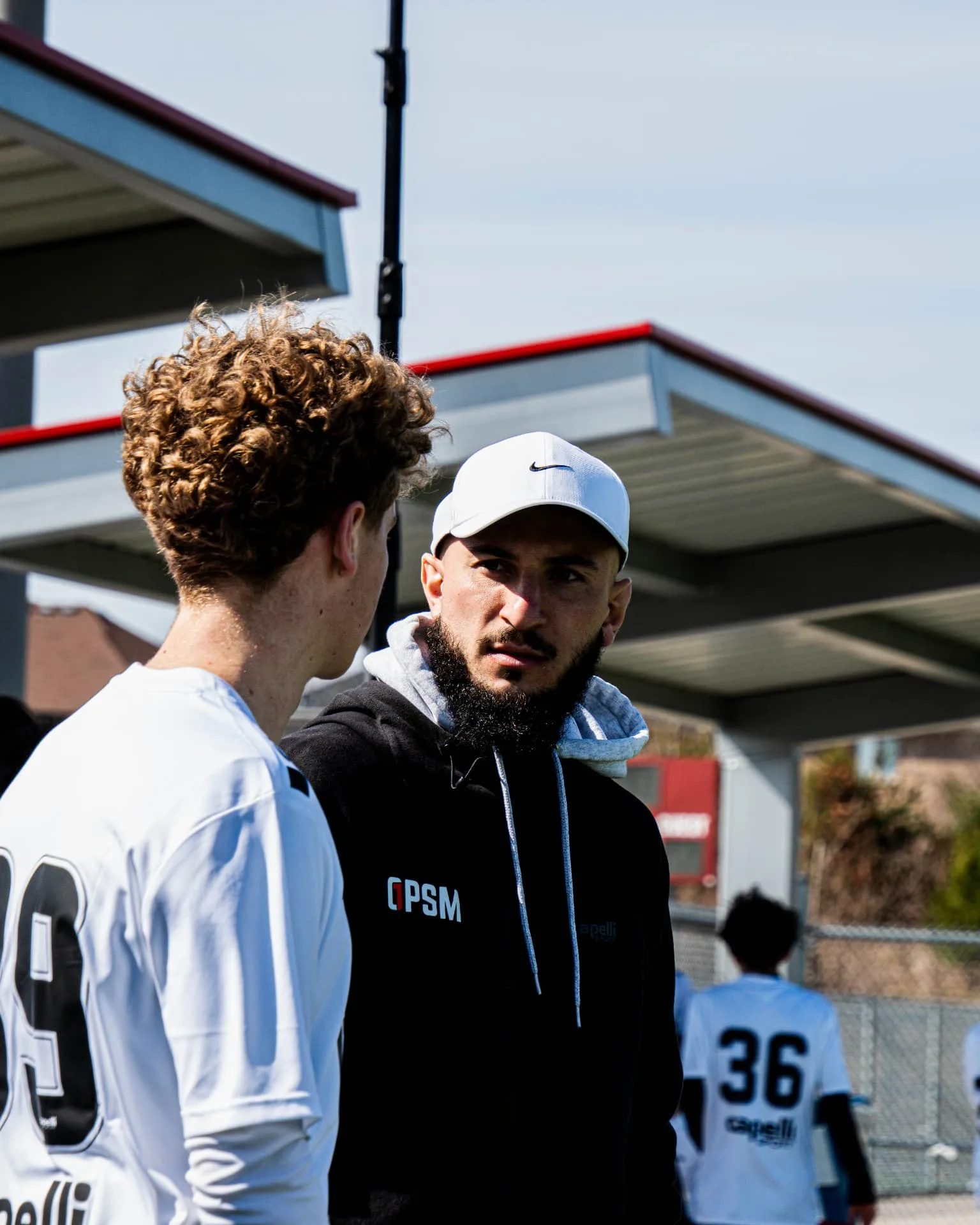 OPSM staff member speaking with a player between sessions